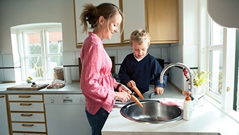 woman cooking with her son